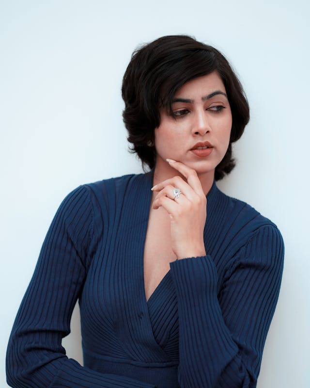 A person standing in a business setting, contemplating a decision, representing the importance of identifying the correct semi-formal task in IELTS General Writing Task 1. - Image 2 - Image 2 - Image 2 - Image 2 - Image 2